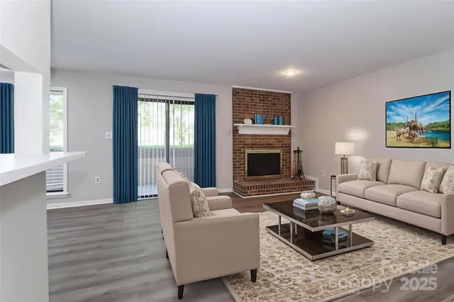 a living room with furniture fireplace and window