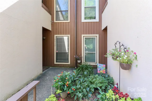 front view of a house with a flower garden