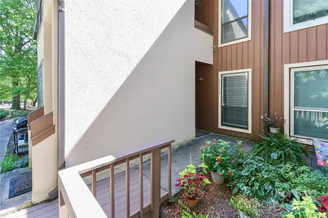 a view of a house with potted plants