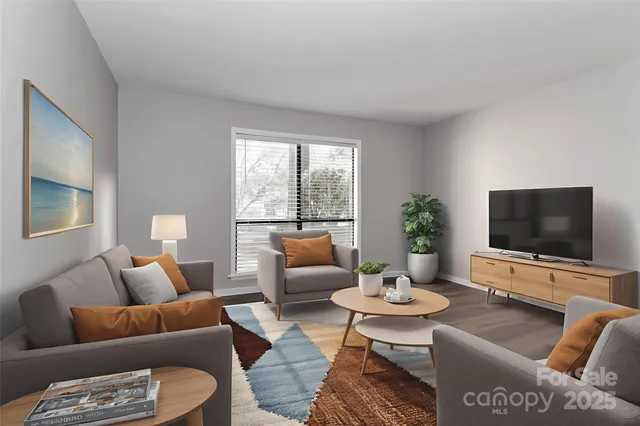 a living room with furniture a flat screen tv and a large window