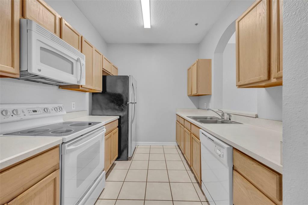 582 Brantley Terrace Way, Unit 304 Altamonte Springs, FL 32714 - Photo 15 of 30 a kitchen with a sink stove and cabinets