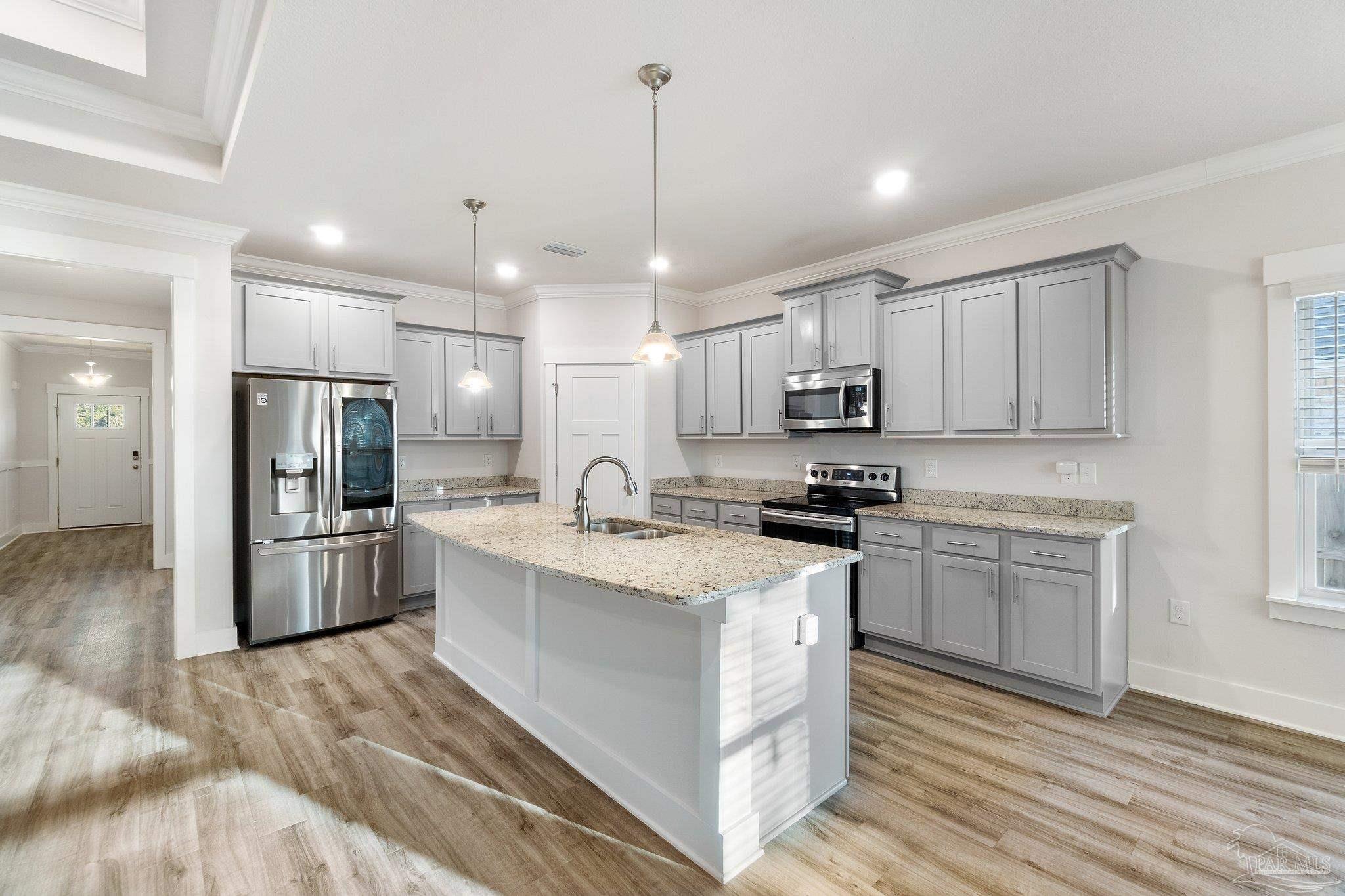 4527 Jude Way Pace, FL 32571 - Photo 11 of 38 a kitchen with stainless steel appliances granite countertop a sink stove and refrigerator