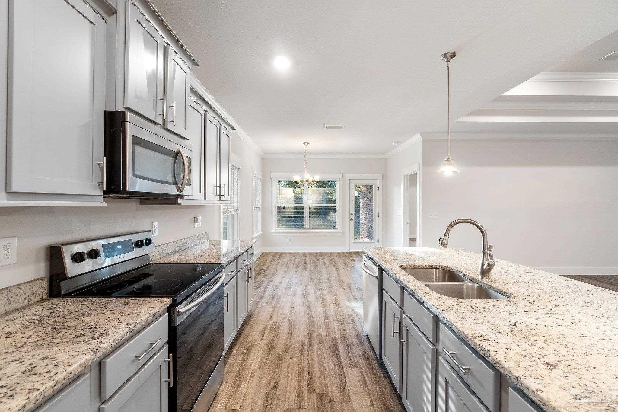 4527 Jude Way Pace, FL 32571 - Photo 13 of 38 a kitchen with granite countertop stainless steel appliances and wooden cabinets