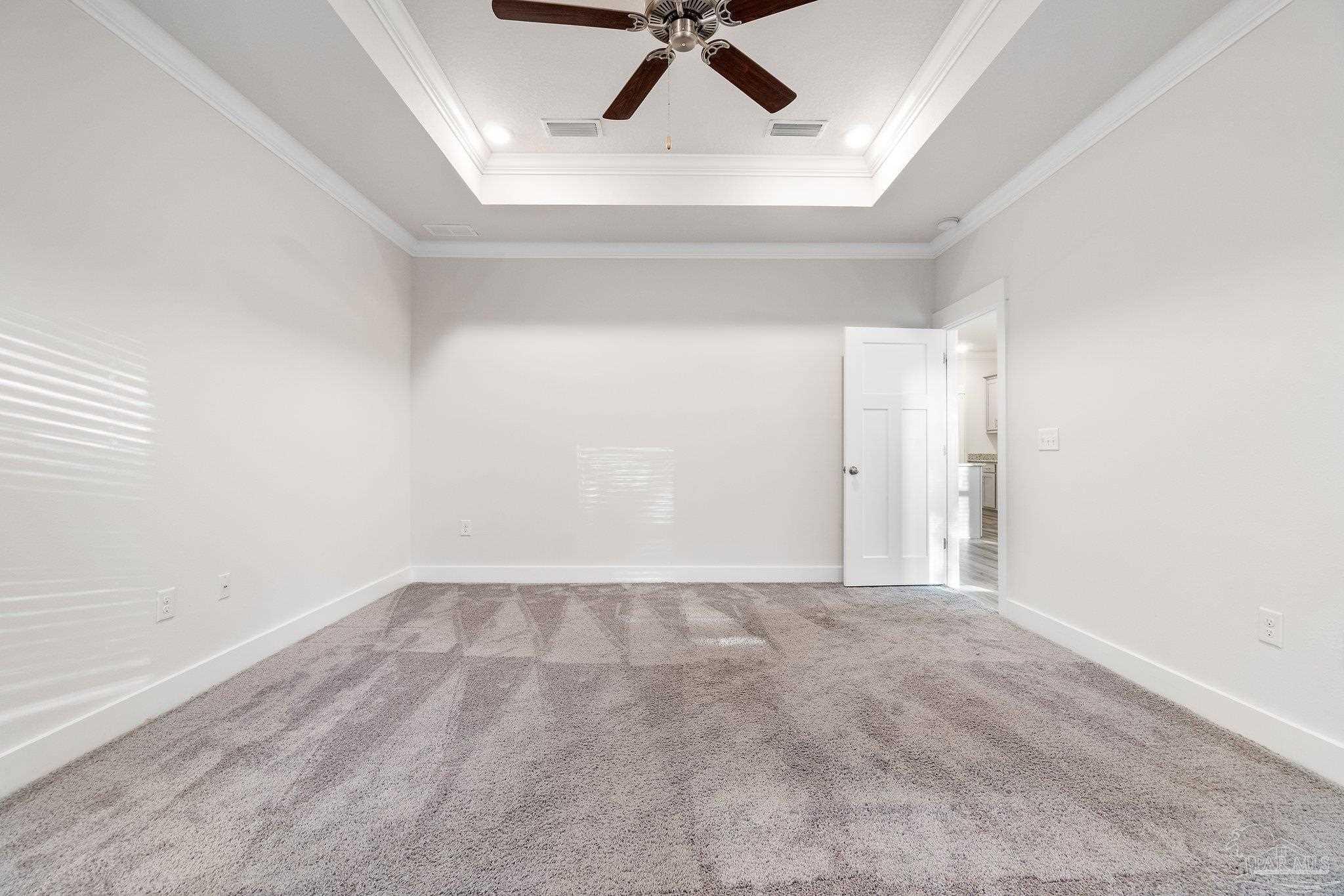 4527 Jude Way Pace, FL 32571 - Photo 19 of 38 an empty room with a ceiling fan and carpet