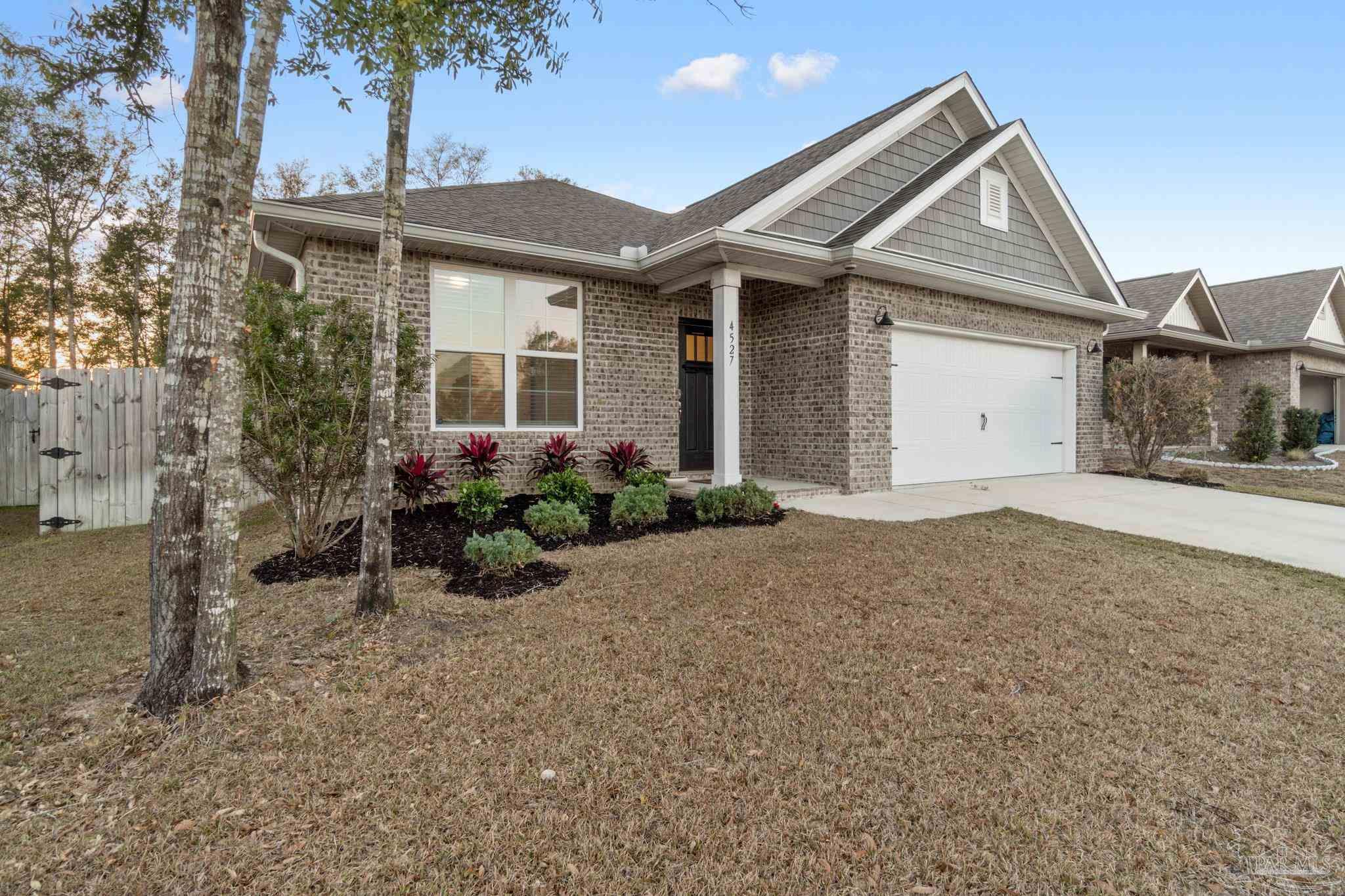 4527 Jude Way Pace, FL 32571 - Photo 2 of 38 a front view of a house with a yard