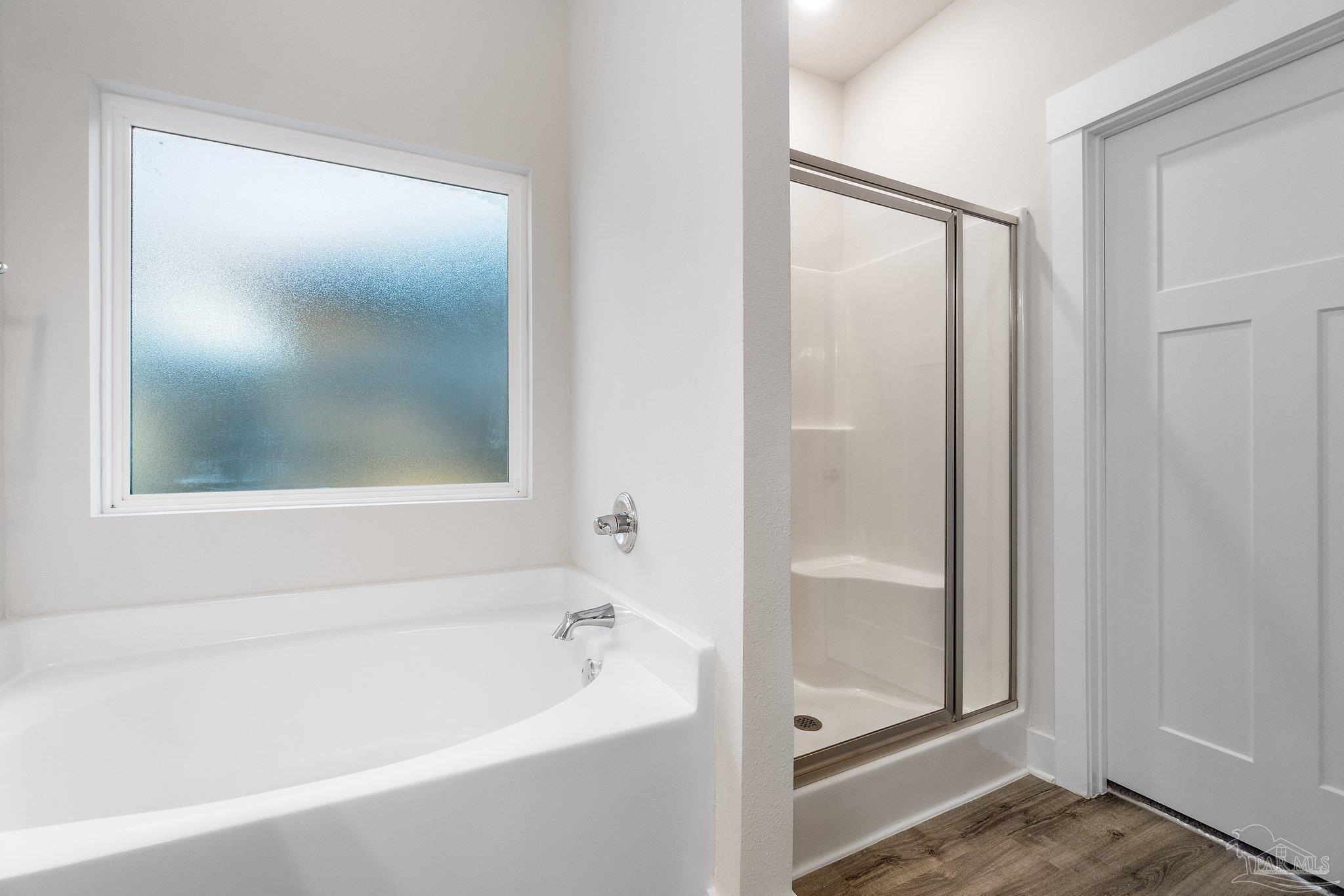 4527 Jude Way Pace, FL 32571 - Photo 23 of 38 a bathroom with a bathtub and a shower