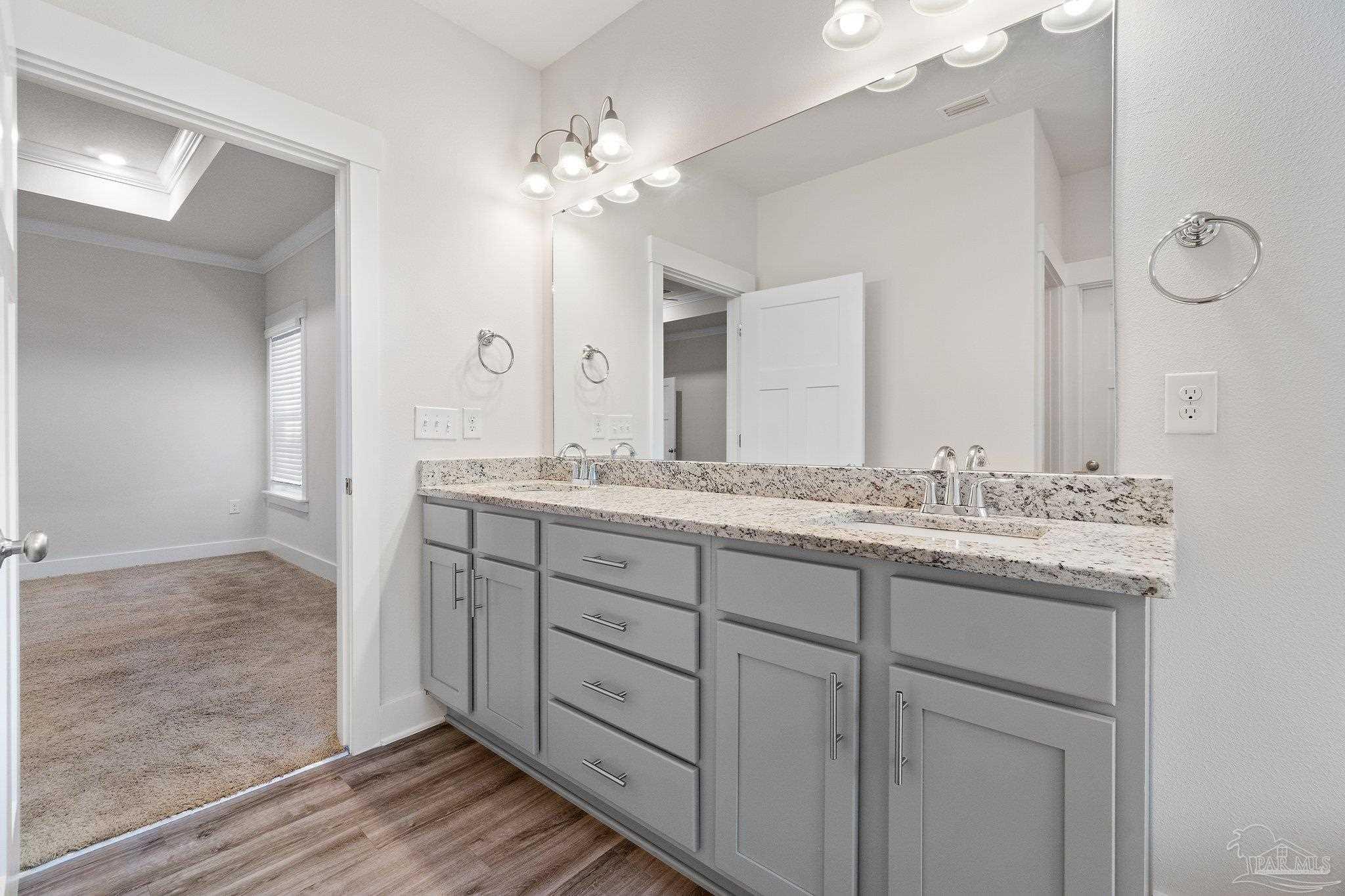 4527 Jude Way Pace, FL 32571 - Photo 25 of 38 a bathroom with a granite countertop sink and a mirror