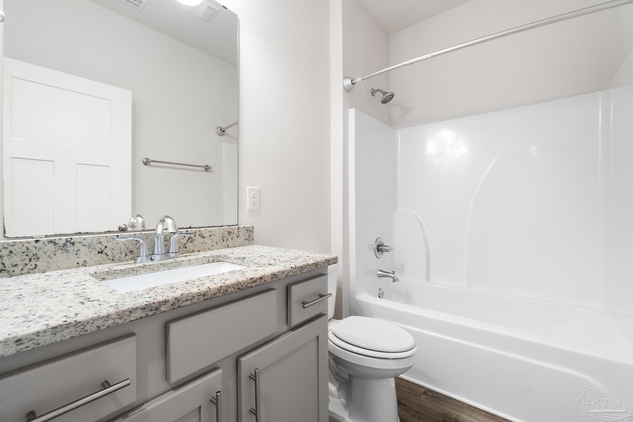 4527 Jude Way Pace, FL 32571 - Photo 30 of 38 a bathroom with a granite countertop sink toilet and shower