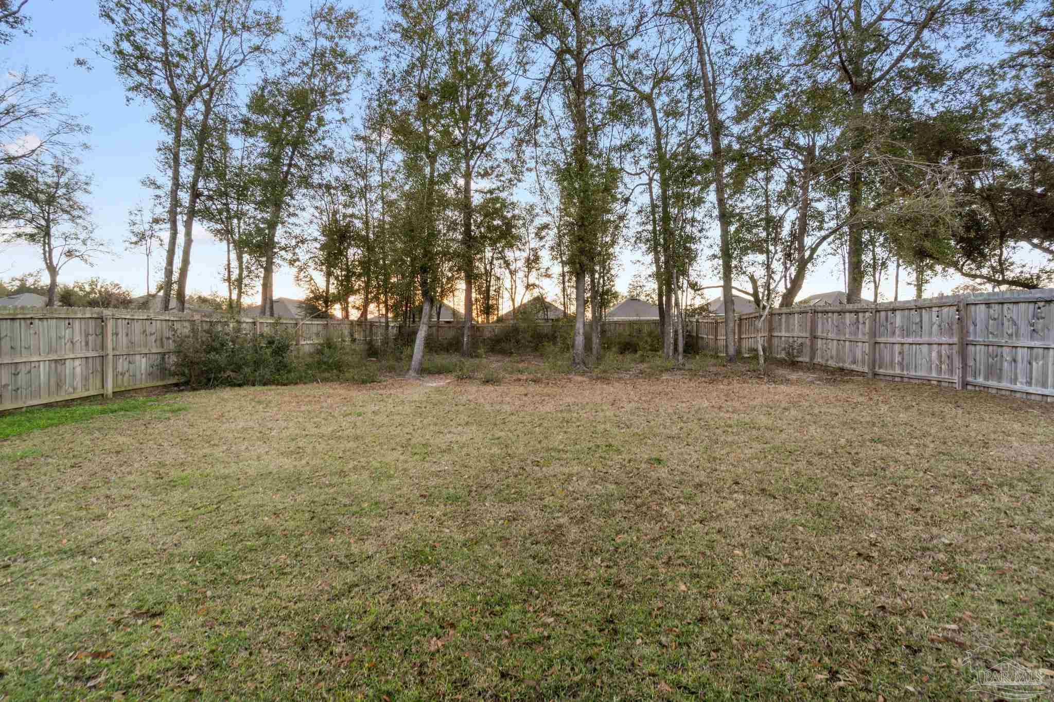 4527 Jude Way Pace, FL 32571 - Photo 38 of 38 a view of a backyard with large trees