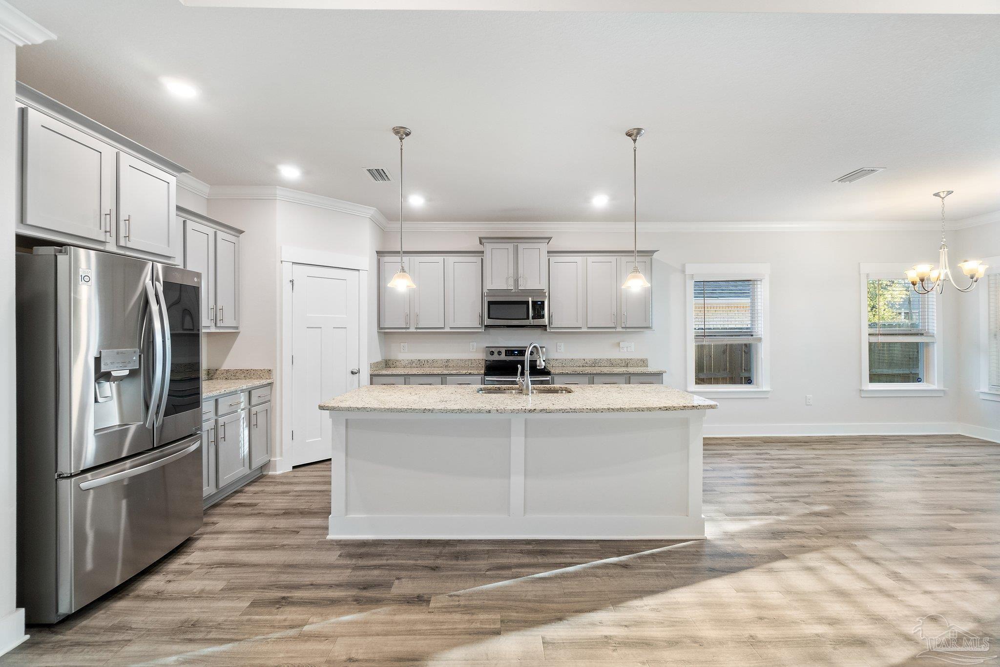4527 Jude Way Pace, FL 32571 - Photo 10 of 38 a view of a kitchen with stainless steel appliances granite countertop a refrigerator a stove and a sink