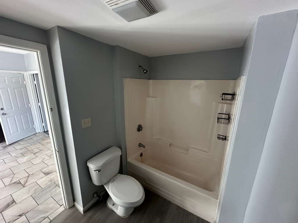 27 Willow Street, Unit A Lawrence, MA 01841 - Photo 12 of 29 a white toilet sitting next to a bath tub