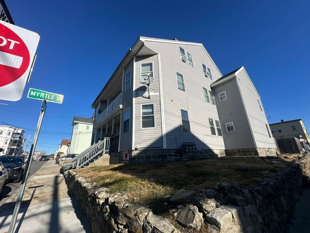 27 Willow Street, Unit A Lawrence, MA 01841 - Photo 3 of 29 a view of a house with a yard