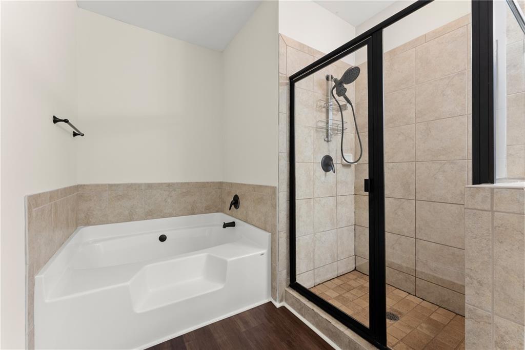 1203 Firethorne Pass Cumming, GA 30040 - Photo 20 of 37 a bathroom with a bathtub and shower