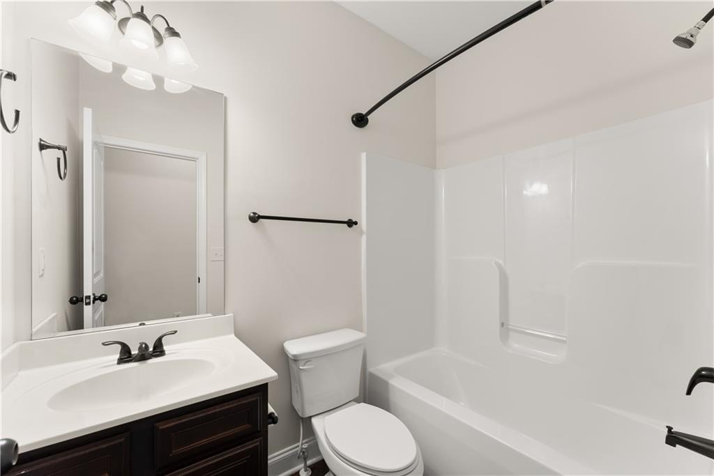 1203 Firethorne Pass Cumming, GA 30040 - Photo 26 of 37 a bathroom with a sink toilet and shower