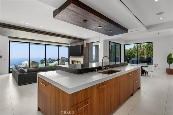 a kitchen with stainless steel appliances granite countertop a sink and a refrigerator
