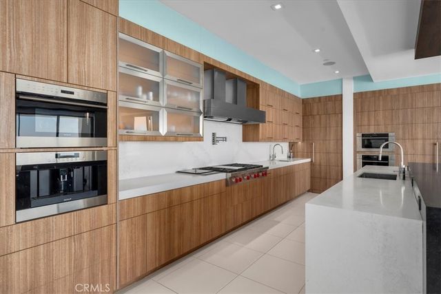 a large kitchen with stainless steel appliances granite countertop a stove and a sink