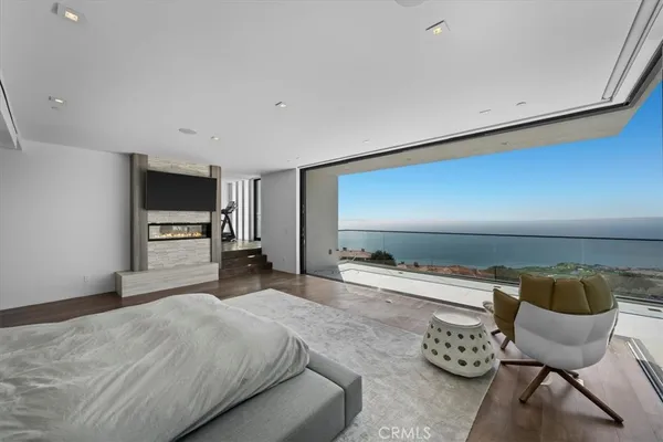 a bedroom with furniture and a flat screen tv