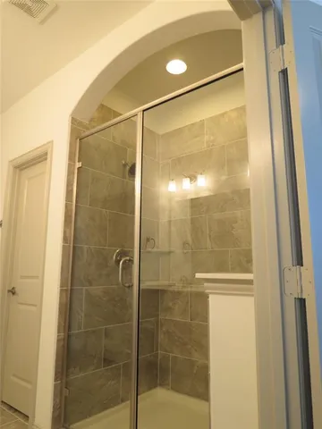 a bathroom with a glass shower door