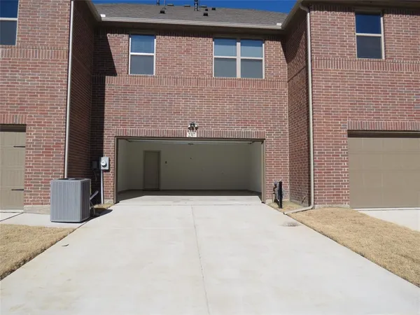a front view of a house with garage