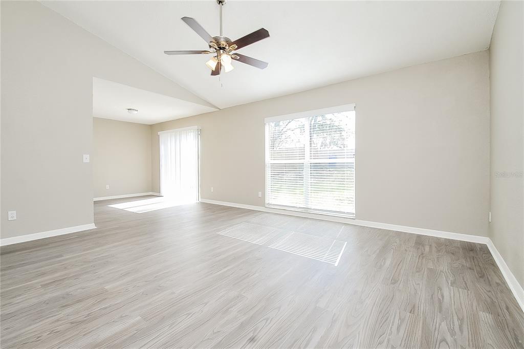 1625 Crossridge Drive Brandon, FL 33510 - Photo 2 of 16 an empty room with wooden floor and windows