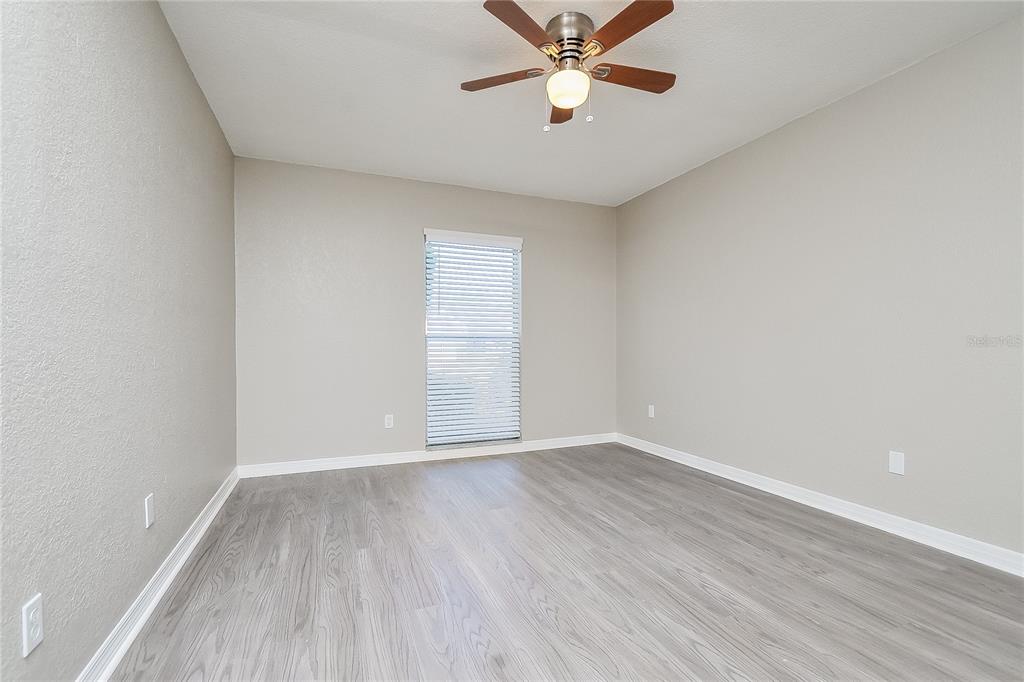 1625 Crossridge Drive Brandon, FL 33510 - Photo 6 of 16 wooden floor in an empty room with a window