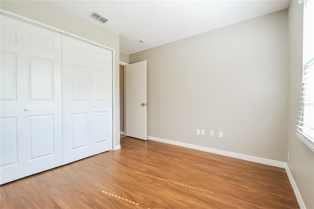 1625 Crossridge Drive Brandon, FL 33510 - Photo 9 of 16 an empty room with wooden floor and windows