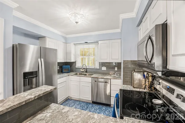a kitchen with a sink appliances and cabinets