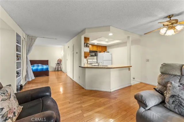 a kitchen with stainless steel appliances a stove microwave and sink