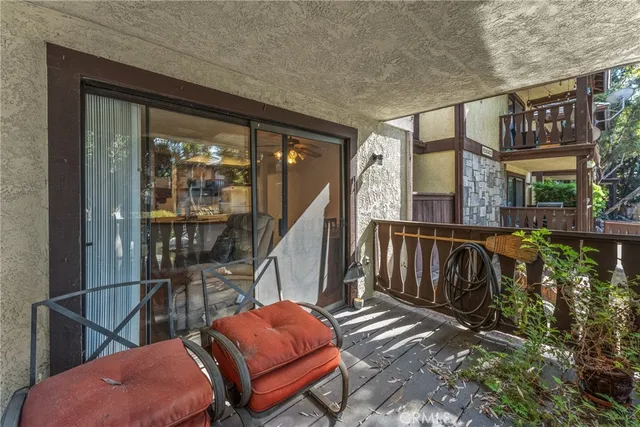 a view of a chair and table in the backyard
