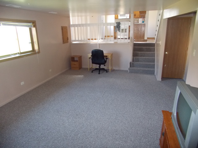 6200 Marsh Lane Matteson, IL 60443 - Photo 13 of 23 a room with a chair and a refrigerator