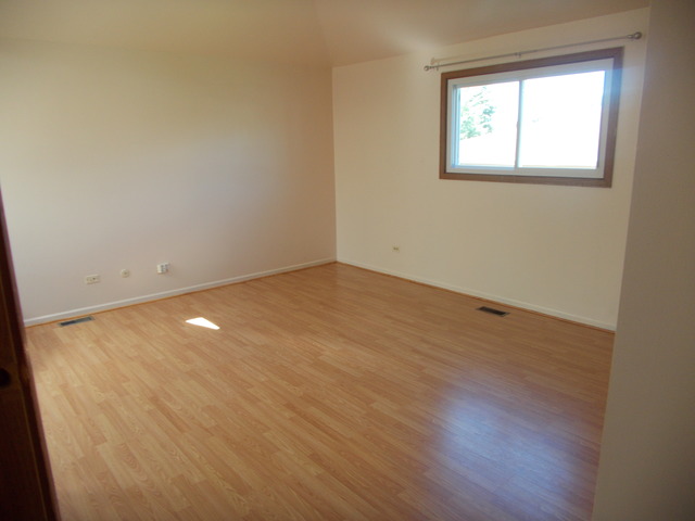 6200 Marsh Lane Matteson, IL 60443 - Photo 16 of 23 an empty room with wooden floor and windows