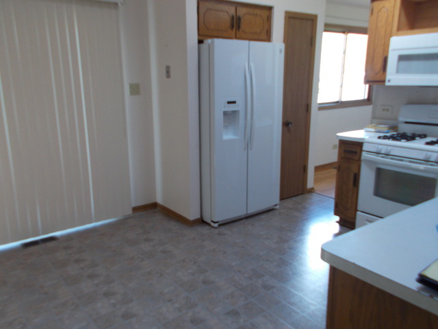 6200 Marsh Lane Matteson, IL 60443 - Photo 21 of 23 a view of a kitchen with fridge and wooden floor