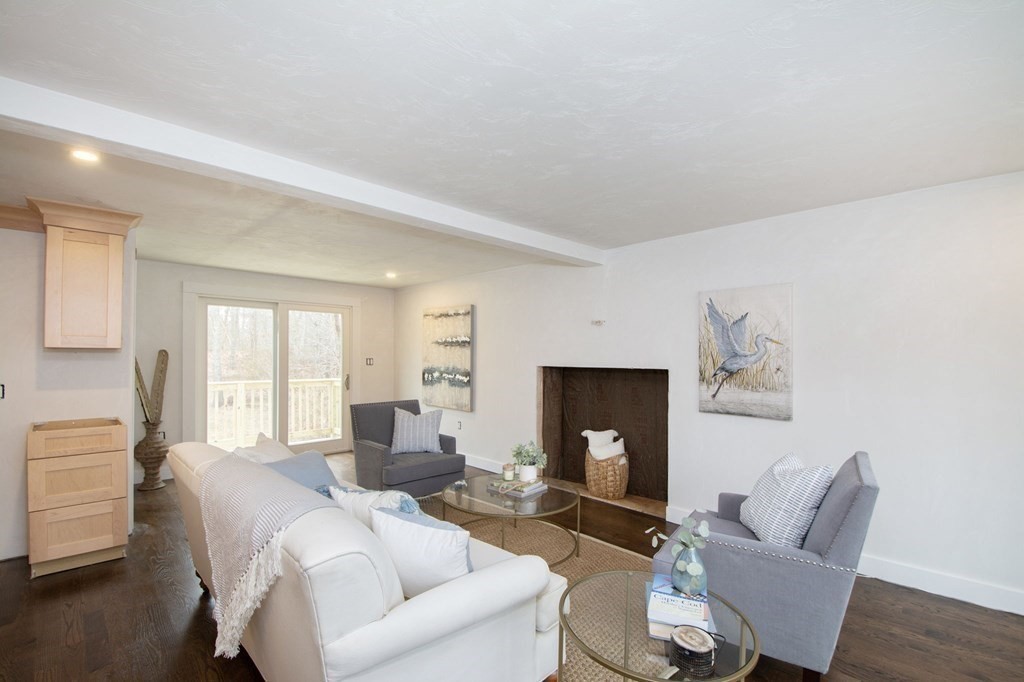 6 Seaview Road Bourne, MA 02562 - Photo 14 of 41 a living room with furniture a fireplace and a window