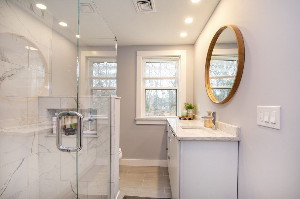 6 Seaview Road Bourne, MA 02562 - Photo 27 of 41 a bathroom with a sink a toilet and a mirror