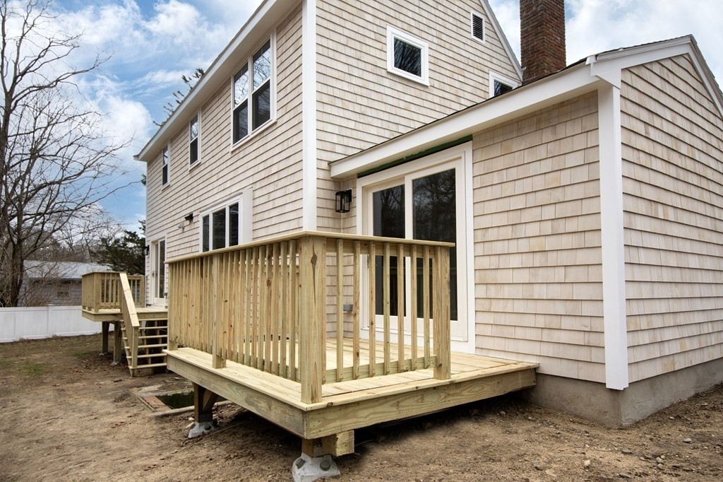6 Seaview Road Bourne, MA 02562 - Photo 4 of 41 a view of a house with a wooden deck