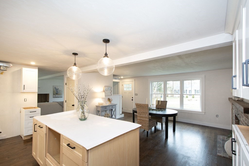 6 Seaview Road Bourne, MA 02562 - Photo 6 of 41 a large kitchen with a table chairs and a refrigerator