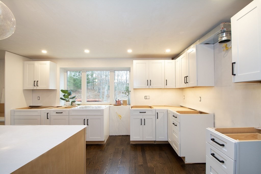 6 Seaview Road Bourne, MA 02562 - Photo 7 of 41 a large white kitchen with a lot of counter space and wooden floor