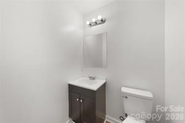 a bathroom with a sink vanity and a toilet