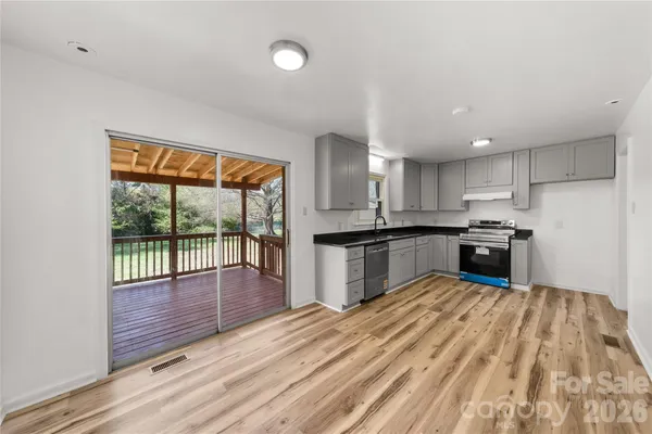 a kitchen with granite countertop a sink and a stove top oven