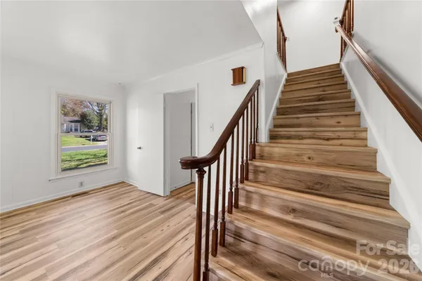 a view of entryway and hall with wooden floor