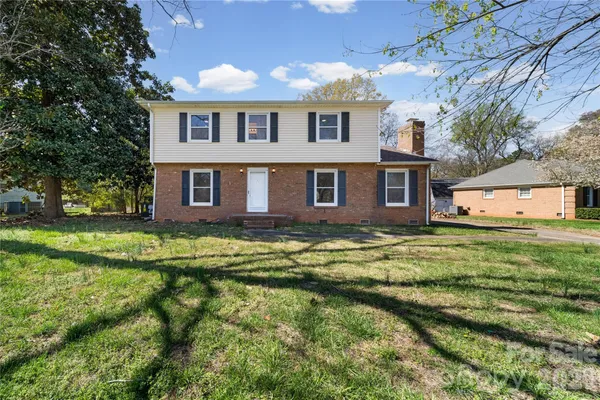 a front view of a house with a yard table and chairs