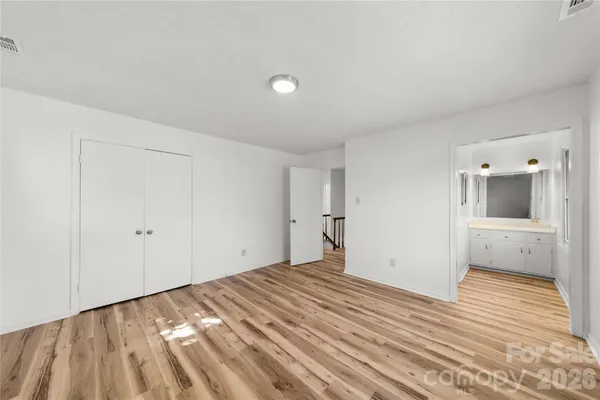 a view of a room with wooden floor