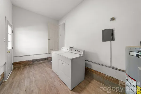 a utility room with cabinets washer and dryer