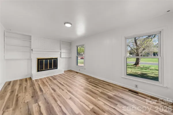 a view of empty room with a fireplace and workspace