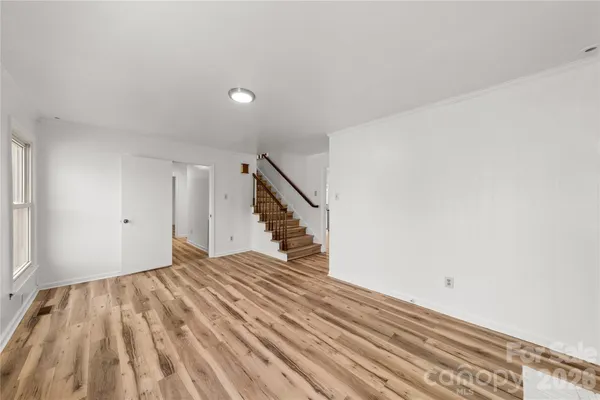 a view of a room with wooden floor and stairs