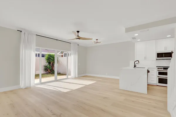 a view of a kitchen with a sink and a refrigerator