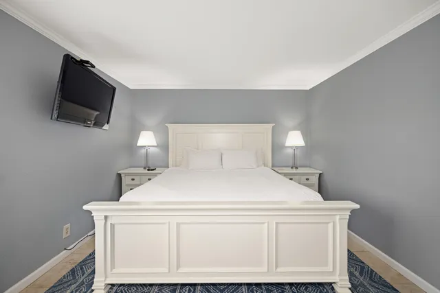 a bedroom with a bed and a flat screen tv