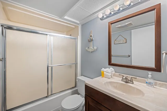 a bedroom with a bed and a flat tv screen on the dresser