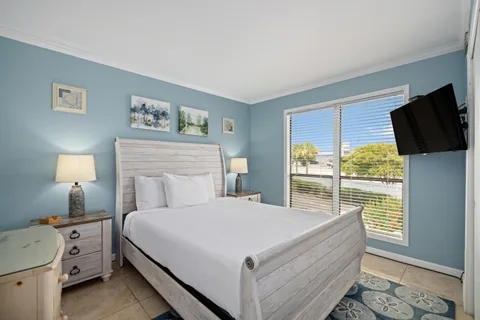 a bedroom with a bed and a television