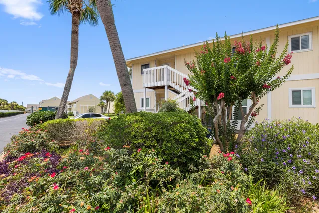 a view of a house with a swimming pool and sitting area